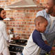 family cooking together in kitchen
